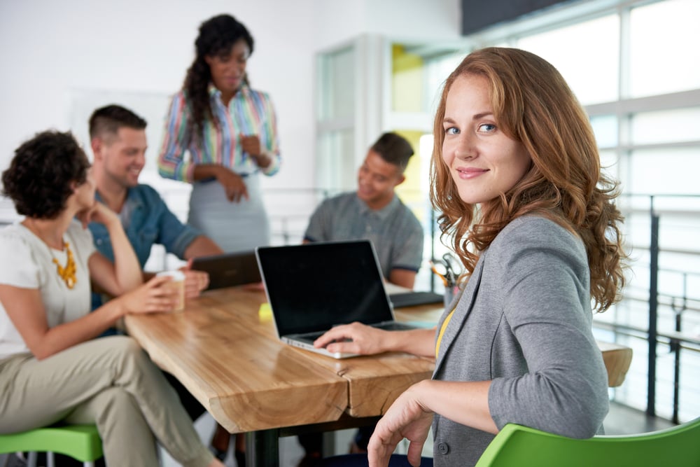 Image of a succesful casual business woman using laptop during meeting-1